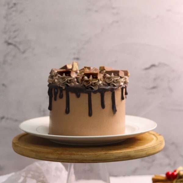 A chocolate tall cake loaded with kit kat and chocolate