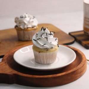 vanilla cupcake with vanilla whipped cream piping