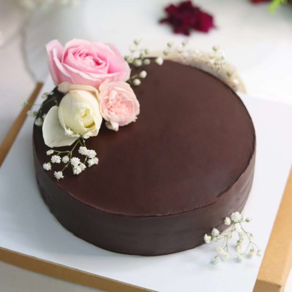 chocolate cake with pink and white roses