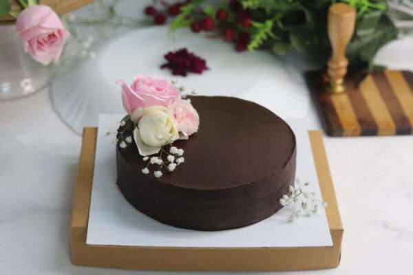 chocolate cake with pink and white roses