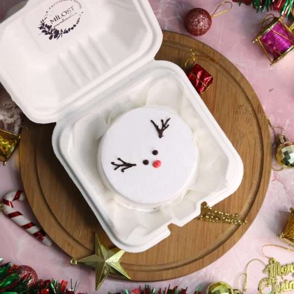A white bento cake with reindeer design