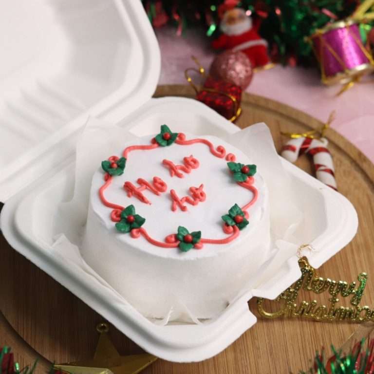 Christmas bento with red pattern and green leaves