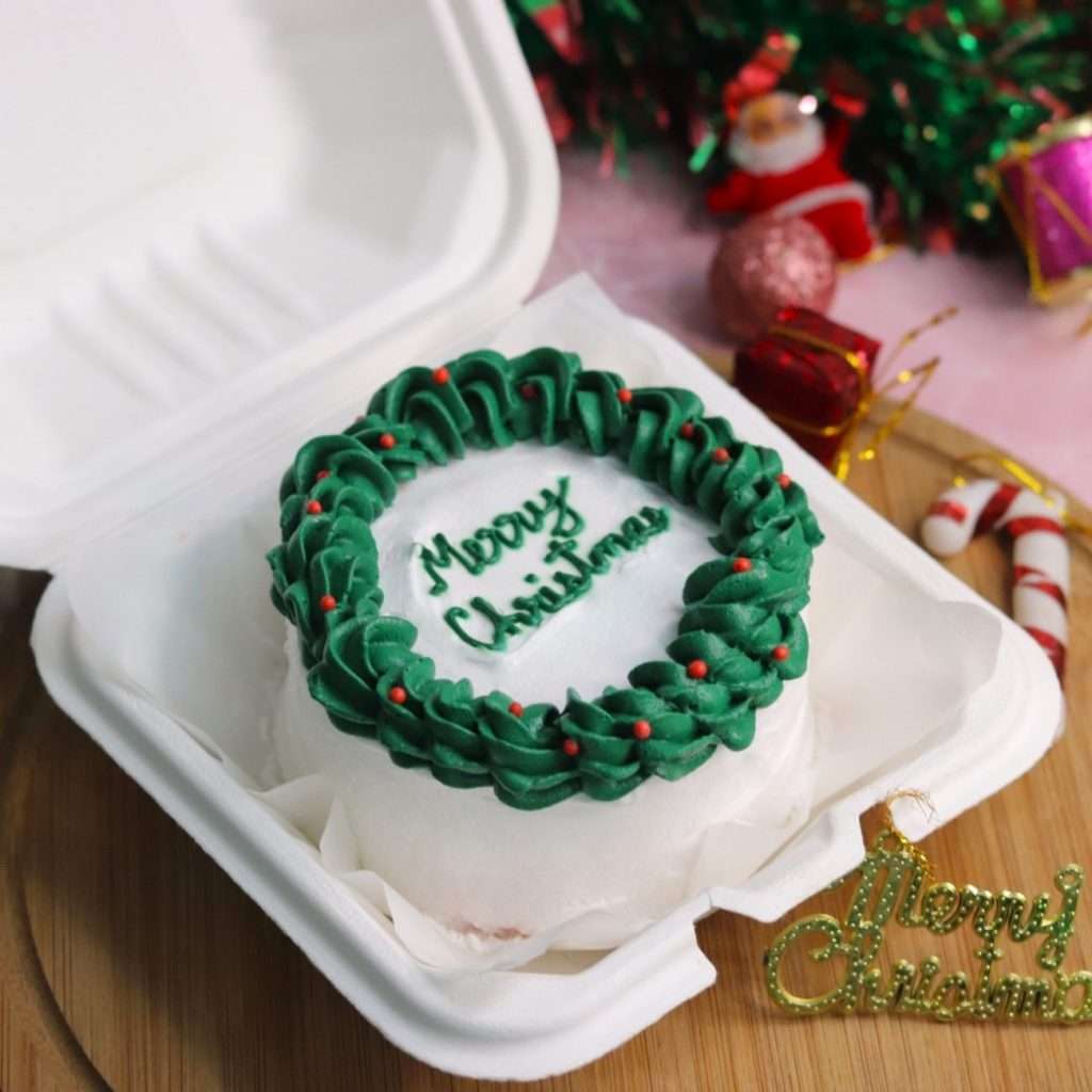 White bento cake with green piping and merry Christmas message