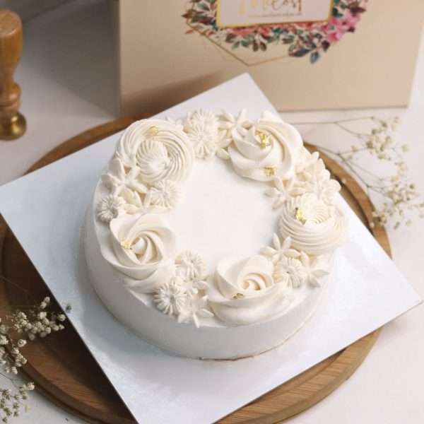 White floral cake with gold leaf